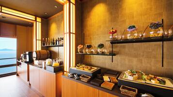 A buffet setup with various food items, a coffee station, and a wine selection.