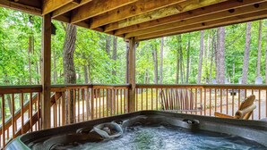 A hot tub in a wooden deck with a view of a forest. - Hidden Mountain Dream, Lake View, Foosball, Hot Tub, Free Attraction Tickets!!! (Sevierville)