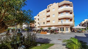 A multi-story building with balconies, outdoor seating, and a central courtyard. - Hotel Boutique HC Maga (Puerto de la Cruz)