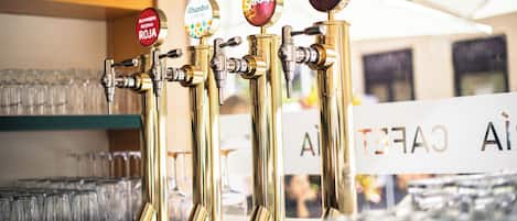 A bar with multiple taps, each labeled with different beer names.