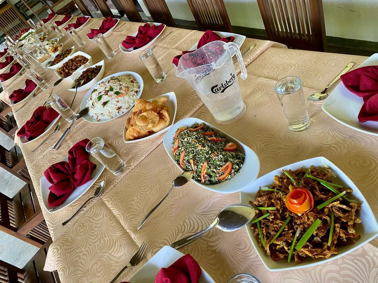 A dining table set with various dishes, glasses, and cutlery, indicating a restaurant setting.