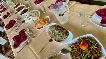 A dining table set with various dishes, glasses, and cutlery, indicating a restaurant setting.