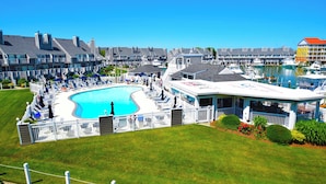 A resort with a large swimming pool, multiple guest rooms, and a marina.