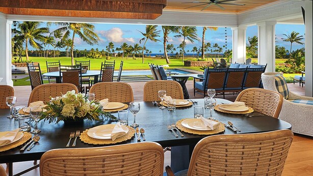 A dining area with a view of a golf course and ocean. - Perfection in Poipu:  Brand new luxury home, ocean views, pool+spa (Koloa)