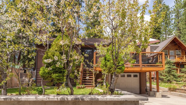 A cabin with a wooden exterior, a covered porch, and a small deck. - Lake Haven- Spacious 5-bedroom, Kings Beach, 12 guests- pet friendly (Kings Beach)