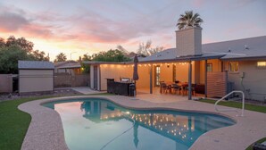 A backyard with a swimming pool, patio furniture, and string lights. - 3 Mi to Dtwn Shops & Eats: Mesa Home w/ Pool! (Mesa)