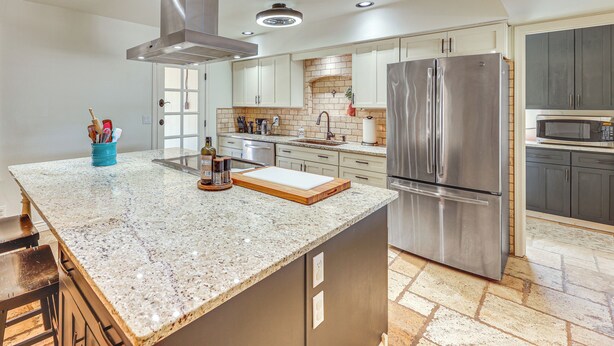 A modern kitchen with granite countertops, stainless steel appliances, and ample storage space. - 3 Mi to Dtwn Shops & Eats: Mesa Home w/ Pool! (Mesa)
