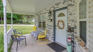 A covered porch with yellow chairs, a bench, and a small table. - Walk to Dtwn: Ironton Home in Historic District (Ironton)