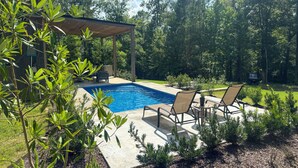 A backyard with a swimming pool, outdoor furniture, and a pergola. - 65 Acres: Secluded 'avian Acres' Cabin w/ Pool! (Burkeville)