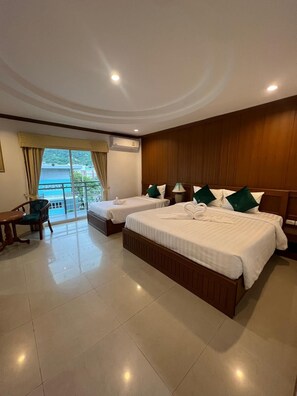 A hotel room with two beds, a desk, and a chair. - SK Residence And Restaurant Patong (Patong)