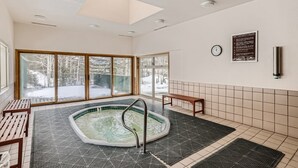 A spa area with a hot tub, wooden benches, and a safety rules sign. - Minutes from Keystone Resort, come enjoy mountain living! (Keystone)