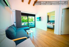 Sweet Home Apartments C | Living area | 55-inch LCD TV with satellite channels - Sweet Home Kemer Apartments (Kemer)