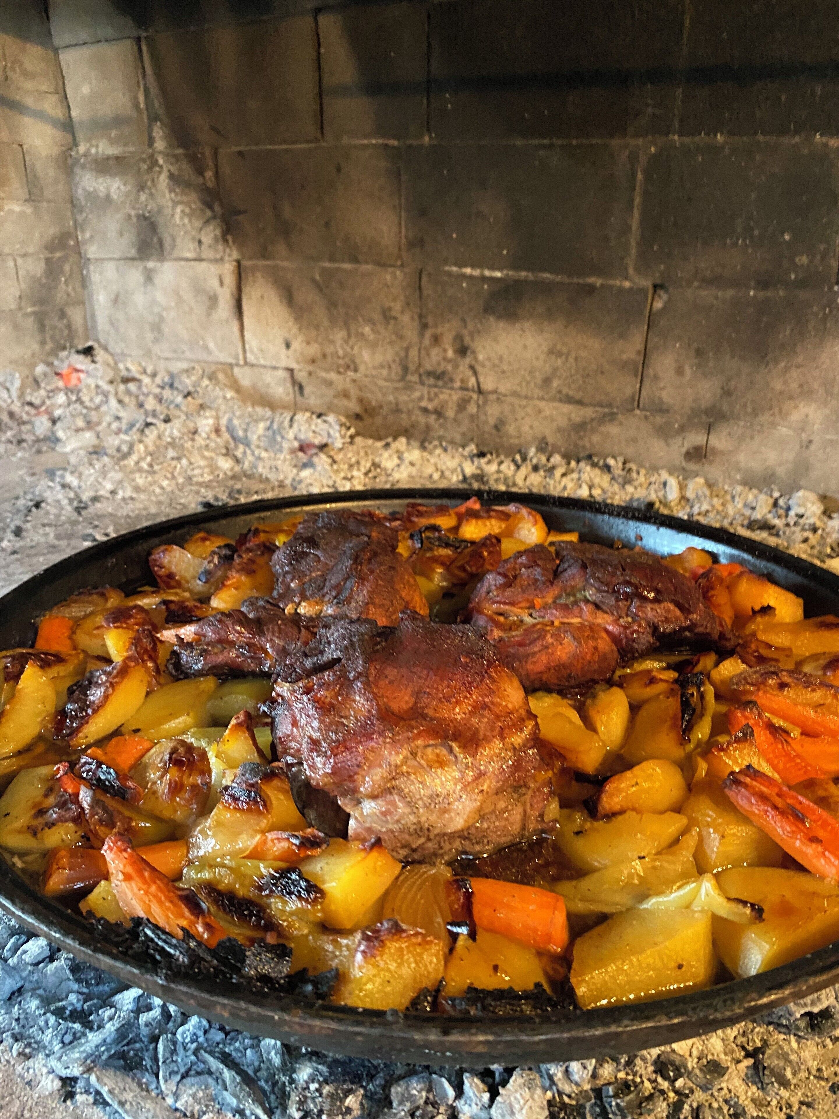 A roasted dish with meat and vegetables in a pan.
