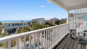 A balcony with a view of the beach and other buildings. - Retreat w/ Private Pool & Ocean View in Surfside Beach (Surfside Beach)