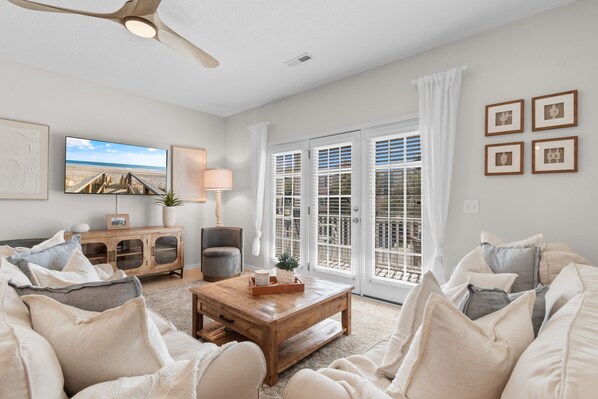 A living room with a wooden coffee table, a television, a sofa, and a cabinet.