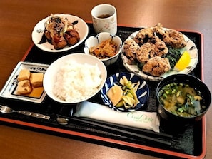 A tray with various Japanese dishes including rice, tempura, and a bowl of soup. - Tetora Higashimuroran (Muroran)