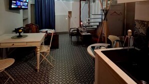 A compact kitchen with a dining area, a TV mounted on the wall, and a patterned floor. - Casuzza at the Dome with a Sea View, within walking distance of the Cathedral! (Agrigento)