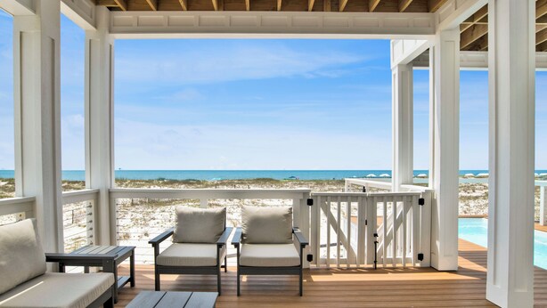 A covered deck with a view of the beach and ocean. - Gulf Front Luxury | Private Heated, Cooled Pool | Elevator and EV Charging (Gulf Shores)