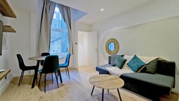 Apartment, City View | Living area | Flat-screen TV