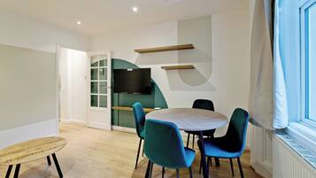 Apartment, City View | Living area | Flat-screen TV