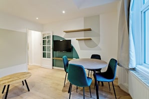 Apartment, City View | Living area | Flat-screen TV