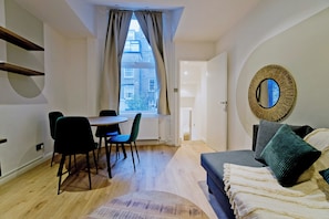 Apartment, City View | Living area | Flat-screen TV