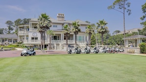 A large, two-story building with a balcony and a clock. - Sunset Rentals- 1687 Bluff Villas (Hilton Head Island)