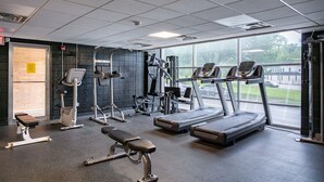 Een sportschool met loopbanden, krachtapparaten en banken.