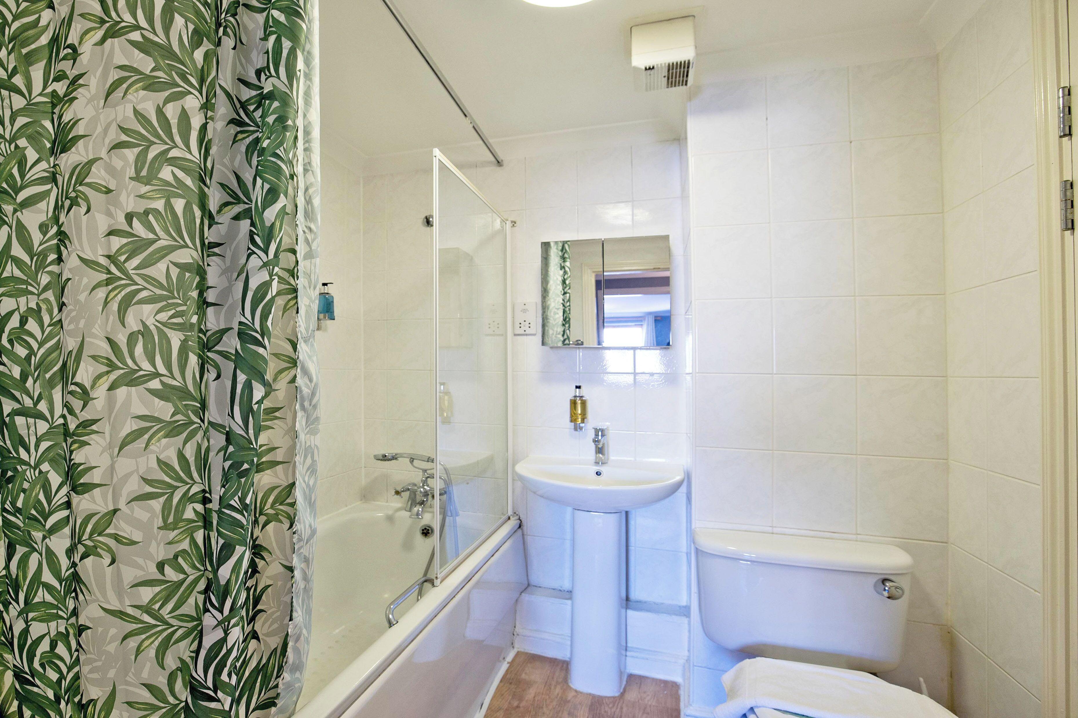 A bathroom with a bathtub, a sink, and a toilet.