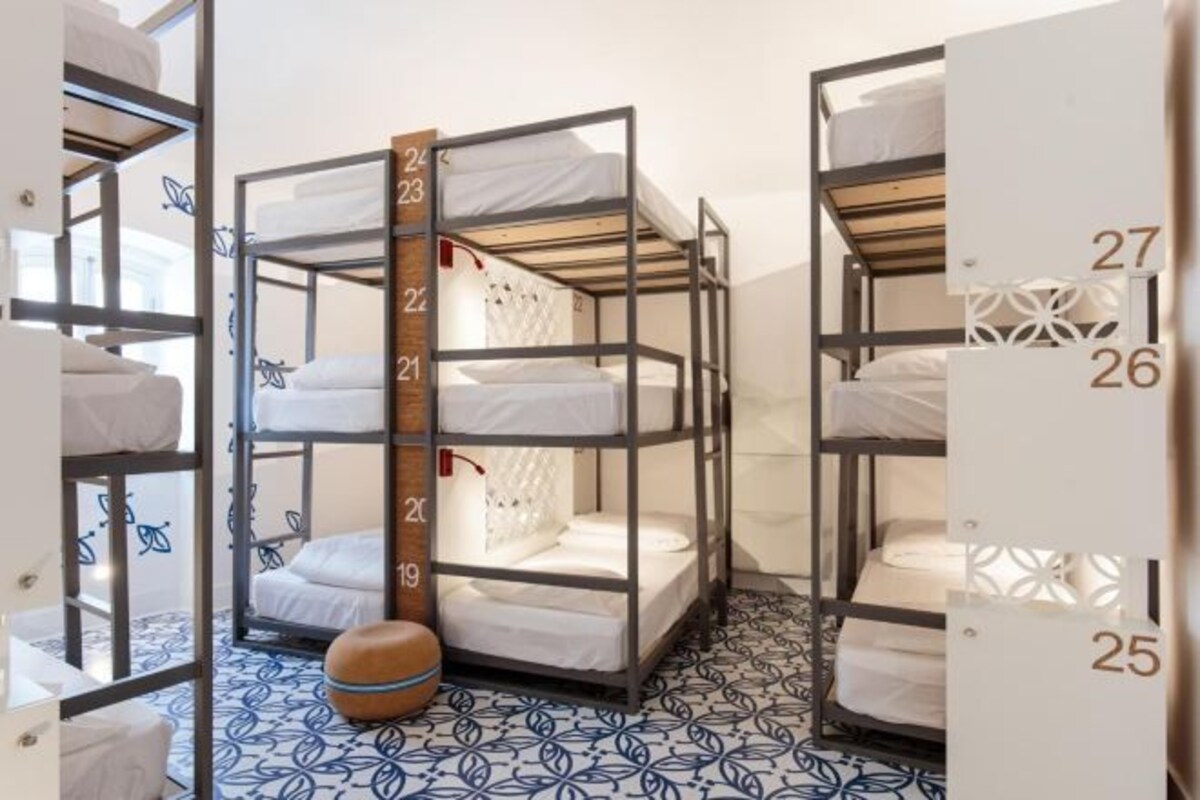 Bunk beds with numbered railings, a patterned floor, and a small round object on the floor.