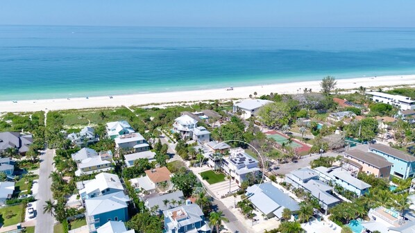 An aerial view of a coastal residential area with houses, a beach, and a clear view of the ocean. - Two Houses from Beach! Rooftop, Pool & Game Room (Holmes Beach)