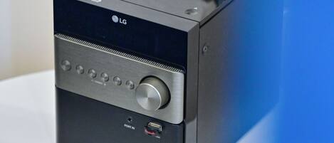 Un sistema de audio LG negro sobre una mesa blanca.