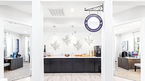 A modern kitchen with a Westwood Terrace sign, black cabinets, and decorative wall art.