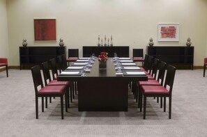 A conference room with a long table, chairs, and a vase of flowers. - Hilton Dead Sea Resort & Spa (Sweimeh)