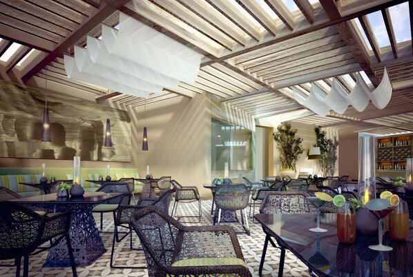A modern interior with high ceilings, geometric ceiling design, and a mix of seating arrangements including tables and chairs. - Hilton Dead Sea Resort & Spa (Sweimeh)
