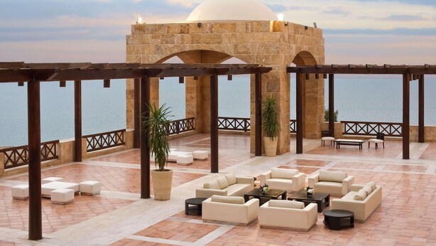 A rooftop terrace with outdoor seating, a large dome structure, and a view of the sea. - Hilton Dead Sea Resort & Spa (Sweimeh)