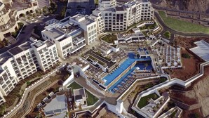 A resort with multiple buildings, a central pool, and surrounding landscaped areas. - Hilton Dead Sea Resort & Spa (Sweimeh)
