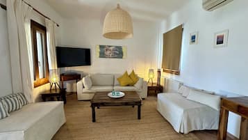 Apartamento família, sacada, vista para o jardim | Área de estar