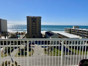 A high-rise hotel with a view of the ocean, a parking lot, and a beach. - Crystal Towers 609, Corner Unit Your Perfect Beach Getaway Awaits You! (Gulf Shores)