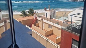 A view of a coastal area with a beach, ocean, and buildings. - Ocean Terrace Quarries. (Las Palmas de Gran Canaria)