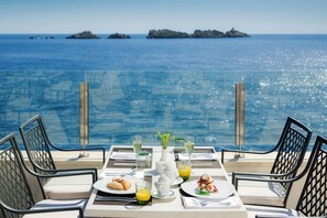 A table set for breakfast with a view of the sea and islands. - Royal Neptun Hotel (Dubrovnik)
