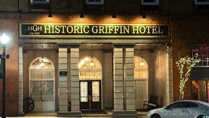 The exterior of the Historic Griffin Hotel with a classic architectural style, featuring arched windows and a prominent entrance.