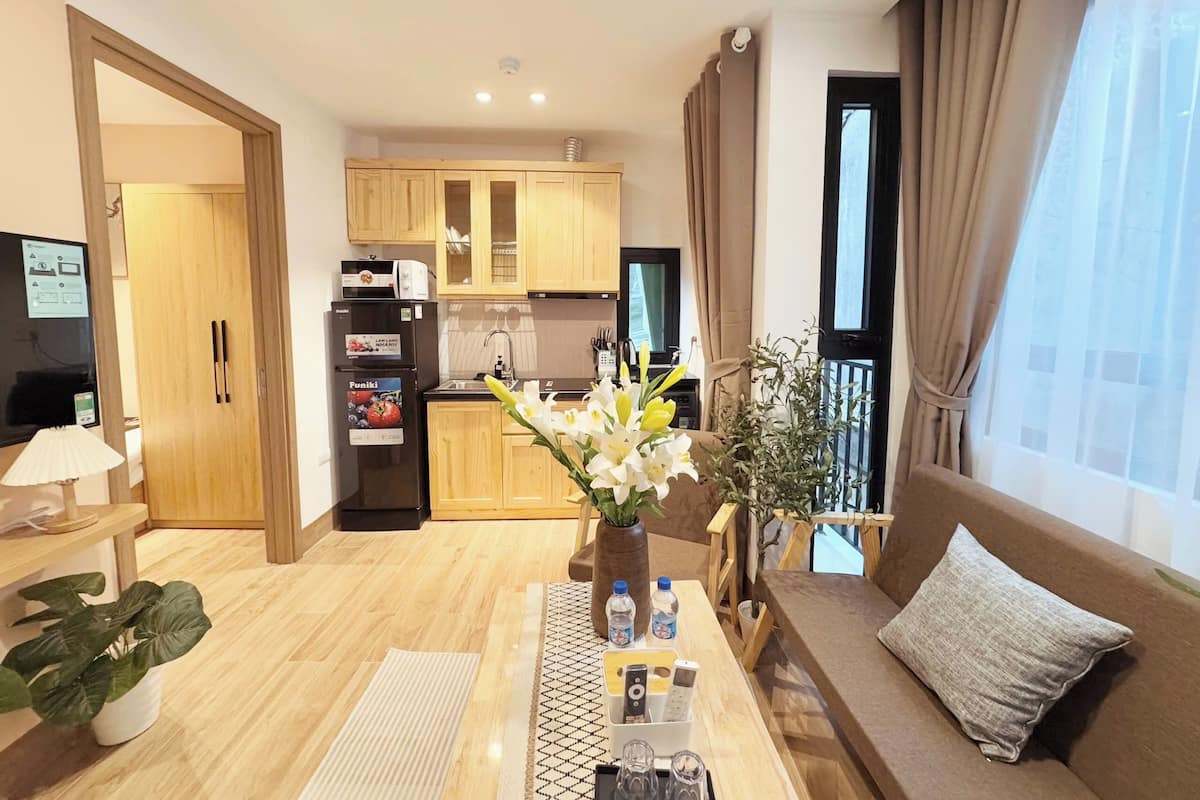 A modern apartment with a kitchen, dining area, and living room.
