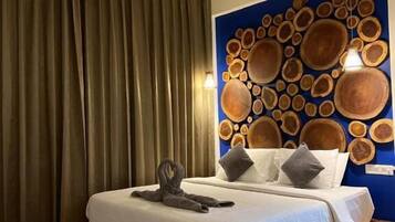 A bedroom with a bed, a ceiling fan, and a wall with circular wooden decorations.