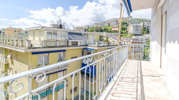 A balcony with a view of neighboring buildings and a clear sky. - GuestHost - Cozy and bright 80 sqm apartment, perfect for 5 people, located on the second floor of a building with a lift.Located in the heart of the Ligurian Riviera, the property is located in Rapallo, in a convenient and well-served area. The location (Rapallo)