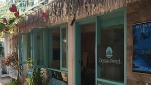 A coastal building with a sign reading "Ocean Pearl." - Ocean Pearl :Deluxe Standard Room (Maafushi)