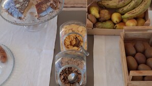 A buffet table with various food items including fruits, nuts, and cereals. - Cala Coralli (Syracuse)
