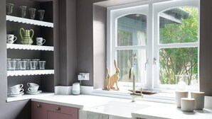 A kitchen with a window, a sink, and a shelf with cups and bowls. - Pretty Riverside Cottage, Petworth
Two Bedrooms, Sleeps 3. Dogs Welcome (Petworth)