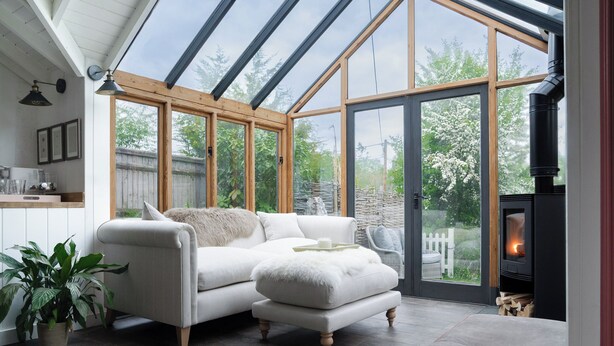A cozy living room with a white sofa, a matching ottoman, and a fireplace. - Pretty Riverside Cottage, Petworth
Two Bedrooms, Sleeps 3. Dogs Welcome (Petworth)