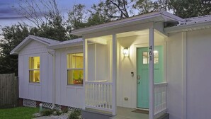A single-story house with a porch, a green door, and a number '461' on the door. - Charming 3BR in St. Augustine - Walk to Downtown, Near Beach, Wifi & A/C! (St. Augustine)